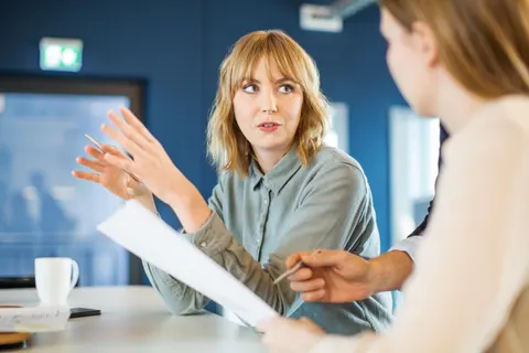 two women talking at the office