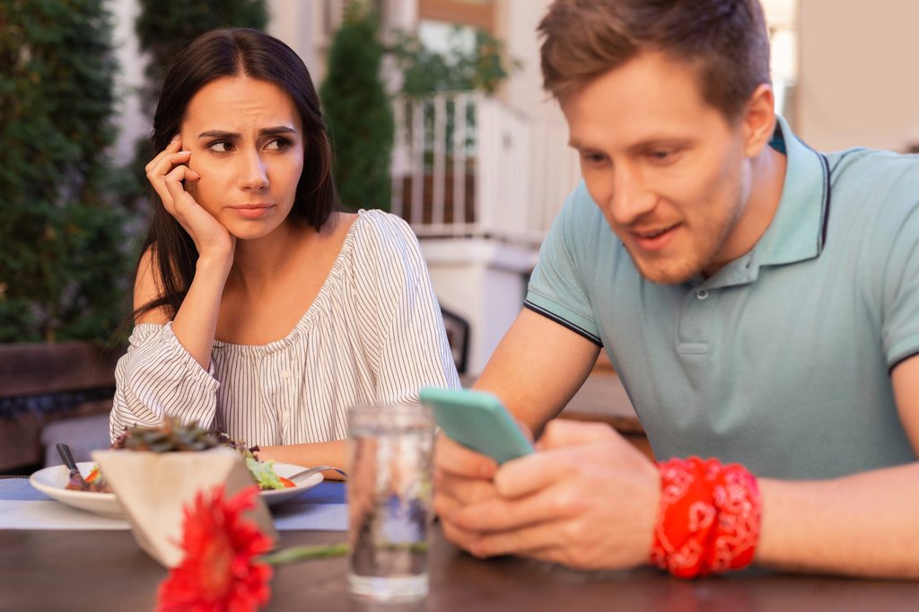 wpman looking annoyed at a man scrolling through his phone