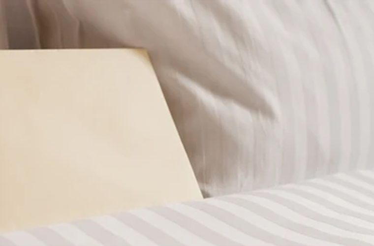 a white envelope sitting on a bed
