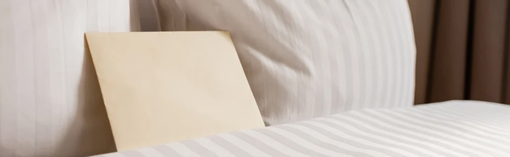 a white envelope sitting on a bed