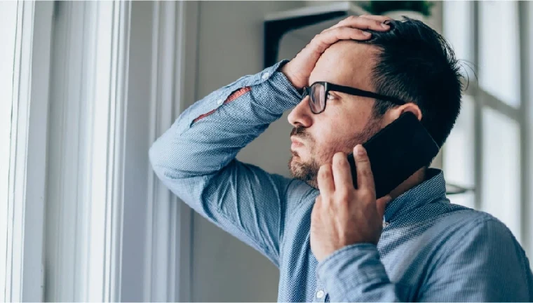 worried man talking of the phone