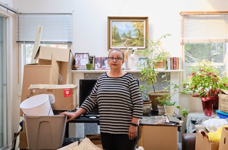 a woman surrounded by moving boxes