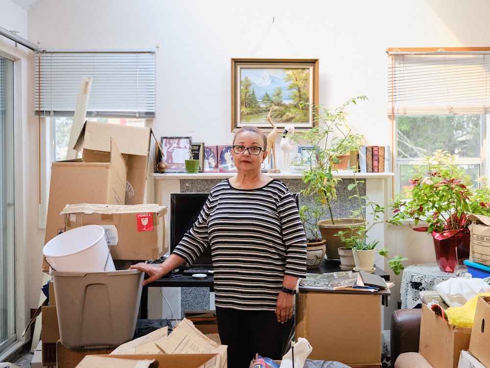 a woman surrounded by moving boxes