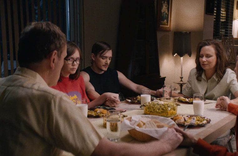 people sitting at a dinner table talking