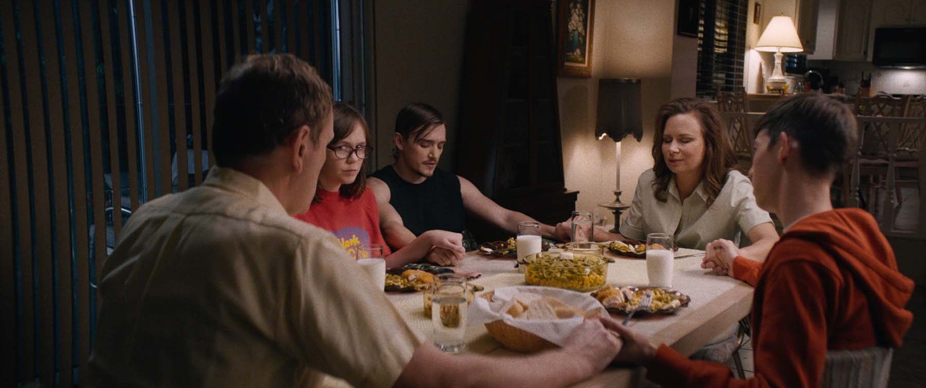 people sitting at a dinner table talking