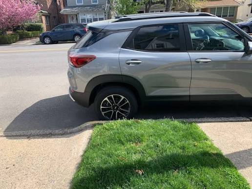 car parked in front of a lawn
