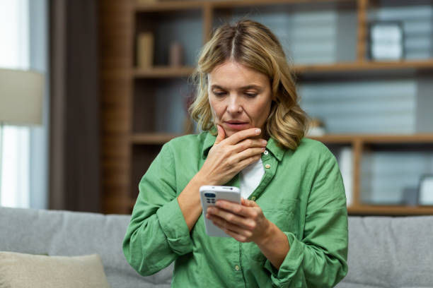 worried woman looking at her phone