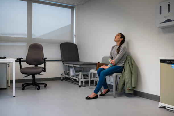 sad woman sitting in a hospital lobby
