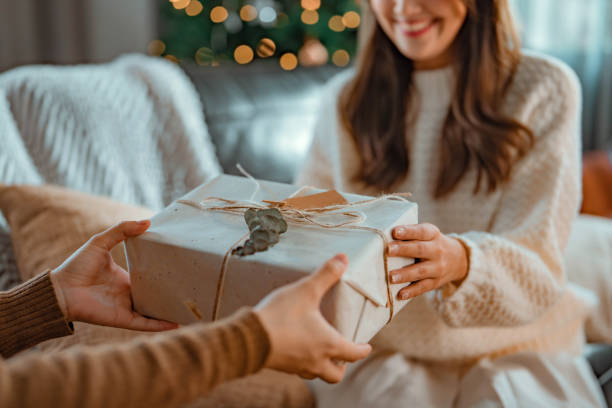 a woman handing a gift to another woman