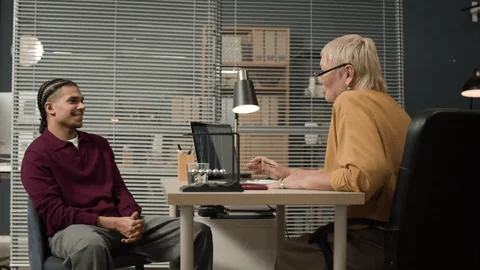 a man and a woman having a conversation in an office